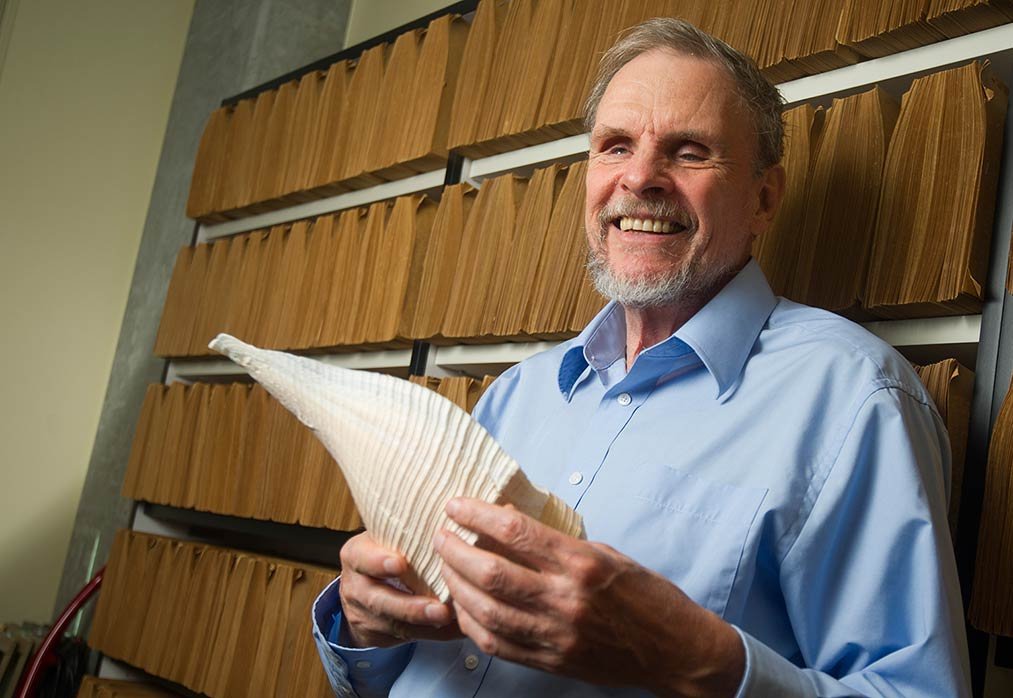 Geerat smiling holding a mollusk