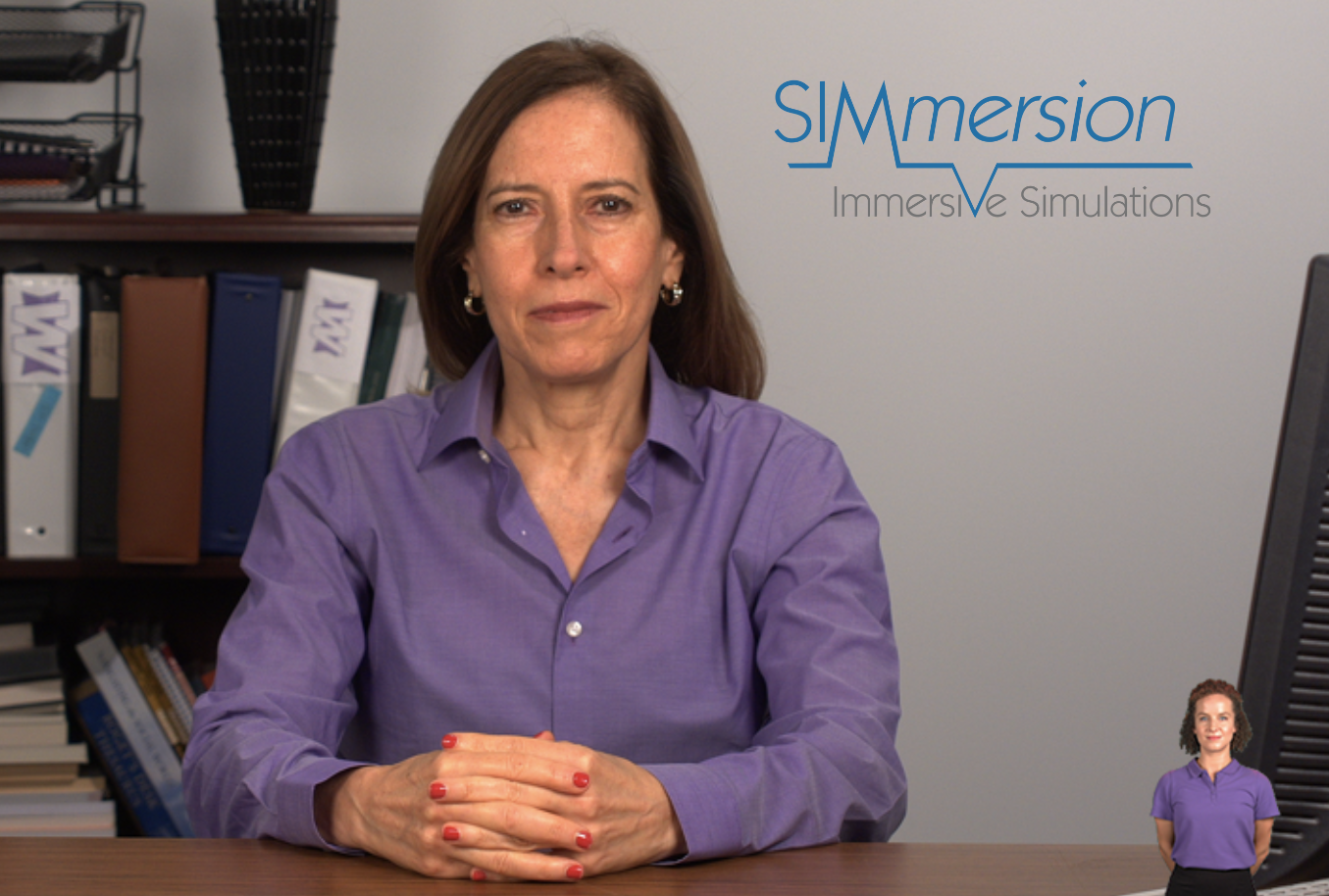 A woman in a purple button-down shirt is seated at a desk. A bookshelf with binders and books is behind her. The SIMmersion logo is at the top.